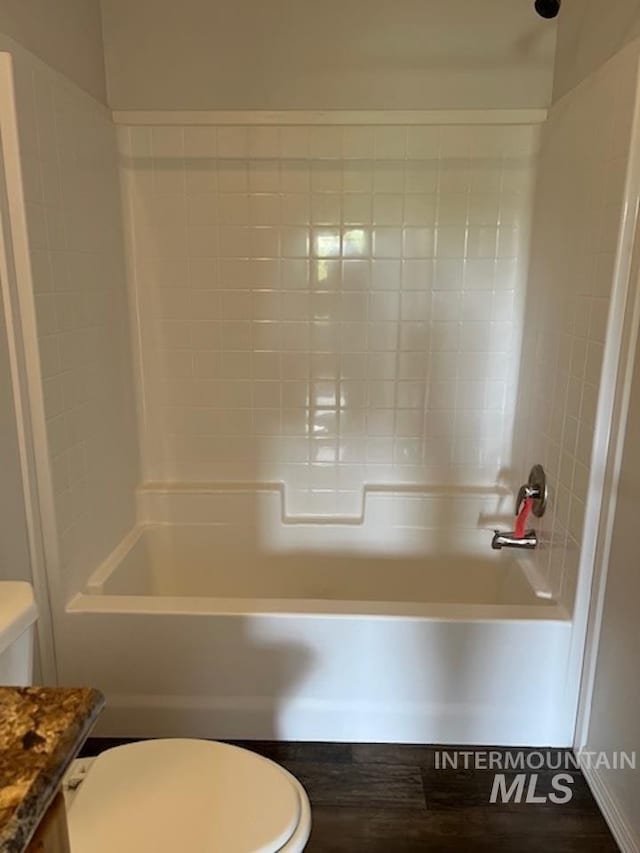 full bathroom featuring toilet, bathing tub / shower combination, and vanity