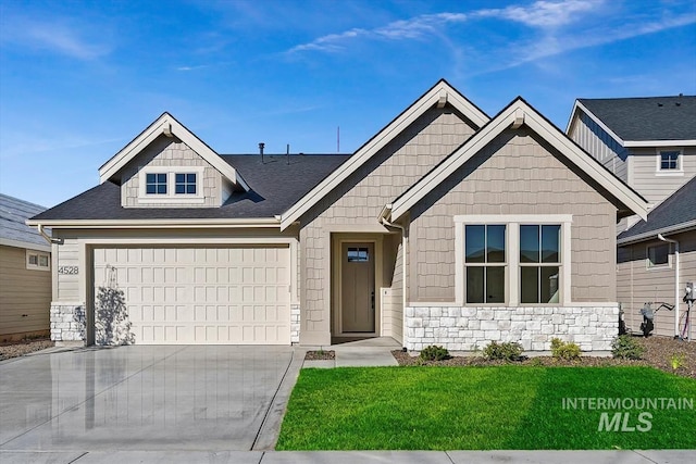 view of front facade with a garage, concrete driveway, a front lawn, and stone siding