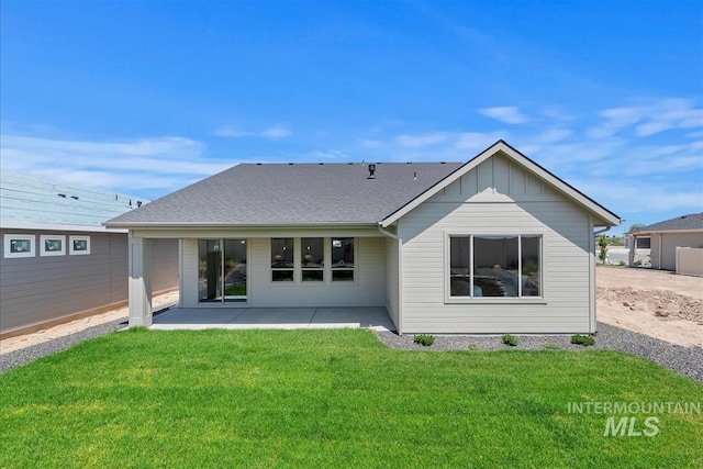 1469 E Andes Dr, Kuna, ID 83634 - rear view of house featuring a patio area, a yard, and board and batten siding