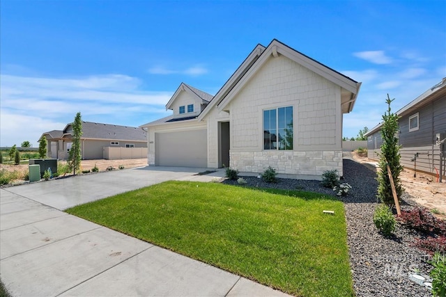 1469 E Andes Dr, Kuna, ID 83634 - view of front of property with stone siding, driveway, and an attached garage