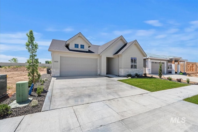 1469 E Andes Dr, Kuna, ID 83634 - view of front facade with a garage, driveway, stone siding, and a shingled roof