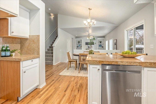 kitchen with white cabinetry, decorative light fixtures, and dishwasher