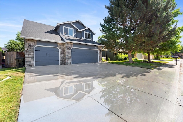 view of front of property with a garage and a front lawn