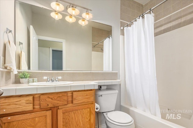 full bathroom featuring vanity, decorative backsplash, toilet, and shower / bath combo with shower curtain