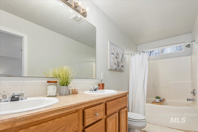 full bathroom featuring vanity, tasteful backsplash, a textured ceiling, toilet, and shower / bath combo with shower curtain