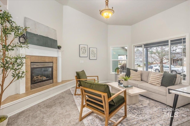 carpeted living room with a tile fireplace