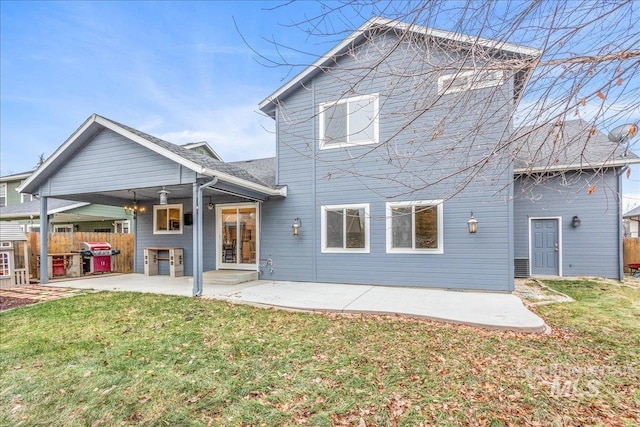 back of property with a patio and a lawn