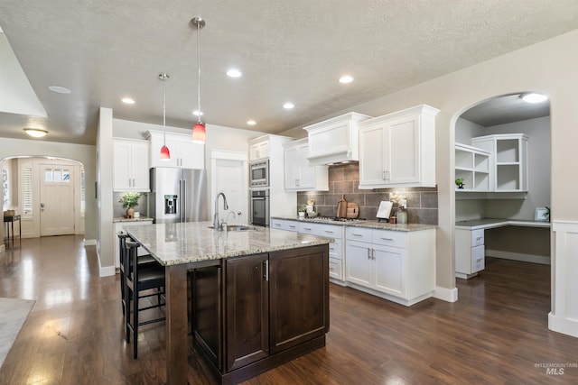 1014 E Carter St, Boise, ID 83706 - kitchen featuring stainless steel appliances, arched walkways, dark wood-type flooring, and recessed lighting