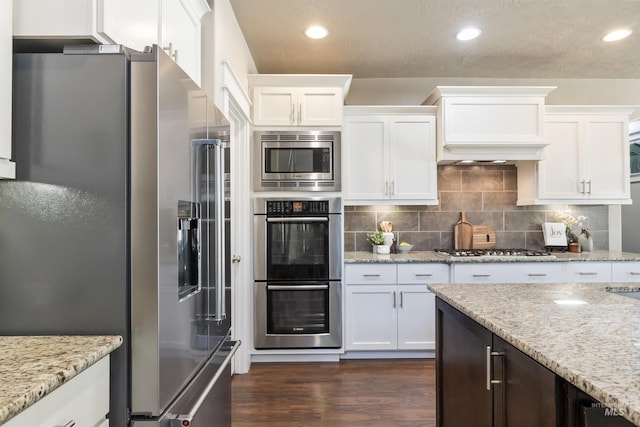 1014 E Carter St, Boise, ID 83706 - kitchen with stainless steel appliances, white cabinetry, dark wood finished floors, recessed lighting, and a textured ceiling
