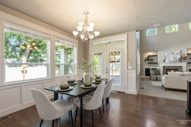 1014 E Carter St, Boise, ID 83706 - dining room with a chandelier, dark wood finished floors, a decorative wall, plenty of natural light, and a fireplace