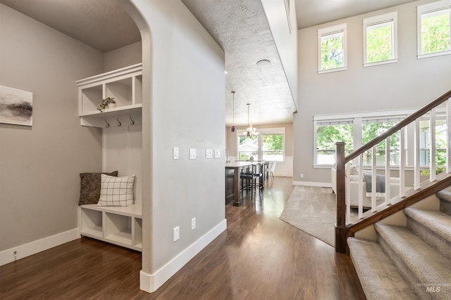 1014 E Carter St, Boise, ID 83706 - mudroom featuring dark wood-style floors, arched walkways, a chandelier, and a high ceiling