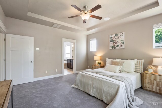 1014 E Carter St, Boise, ID 83706 - carpeted bedroom with a tray ceiling, ensuite bathroom, and a ceiling fan