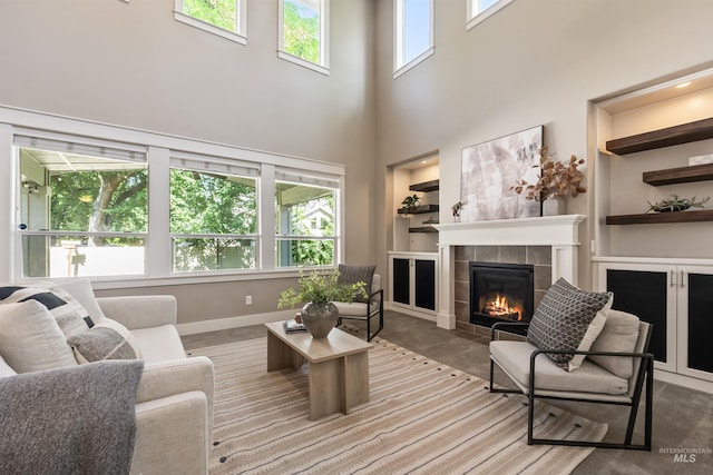 1014 E Carter St, Boise, ID 83706 - living room with built in features, a tile fireplace, and a high ceiling