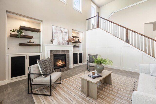 1014 E Carter St, Boise, ID 83706 - living area with carpet, a fireplace, stairs, and a towering ceiling