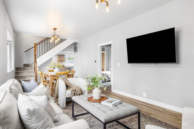 1936 S Leadville, Boise, ID 83706 - living area featuring a chandelier, stairs, wood finished floors, and baseboards