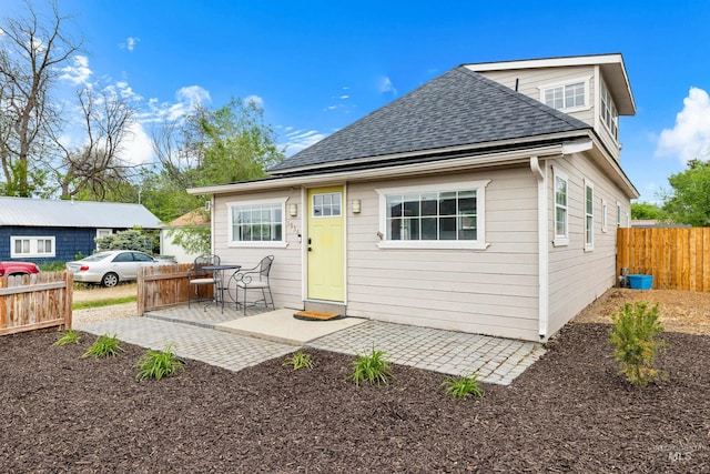 1936 S Leadville, Boise, ID 83706 - back of house featuring roof with shingles, fence, and a patio area