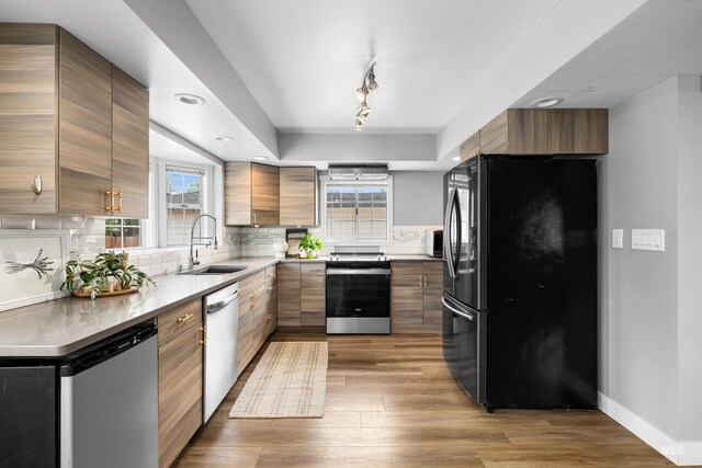 1936 S Leadville, Boise, ID 83706 - kitchen featuring stainless steel appliances, a sink, tasteful backsplash, wood finished floors, and brown cabinets