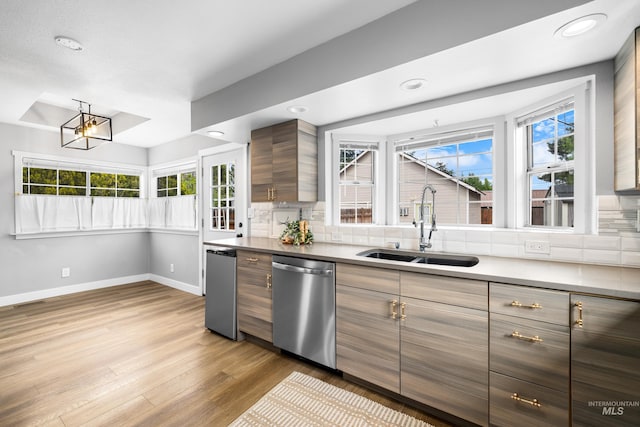 1936 S Leadville, Boise, ID 83706 - kitchen featuring dishwasher, a sink, decorative backsplash, baseboards, and light wood finished floors