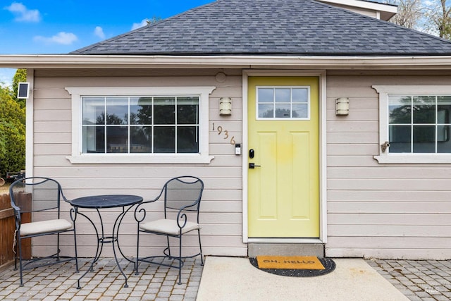 1936 S Leadville, Boise, ID 83706 - view of exterior entry with roof with shingles and a patio