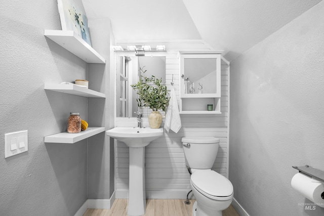 1936 S Leadville, Boise, ID 83706 - bathroom featuring wood finished floors, lofted ceiling, toilet, baseboards, and a sink