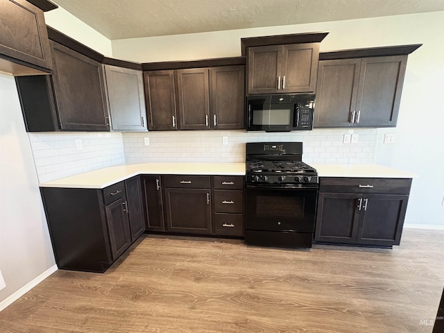 1786 E Cave Falls St, Kuna, ID 83634 - kitchen featuring black appliances, light wood-style flooring, light countertops, and dark brown cabinets