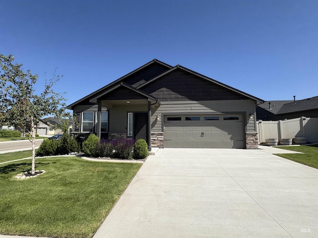 1786 E Cave Falls St, Kuna, ID 83634 - view of front of house featuring a garage, concrete driveway, and stone siding