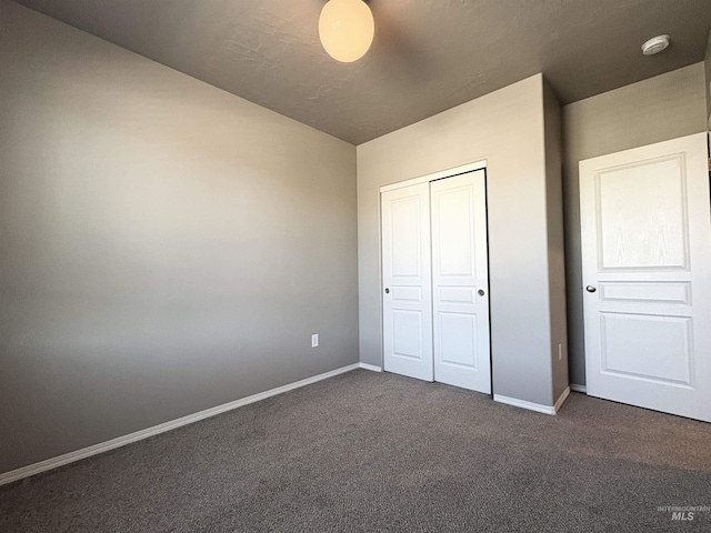 1786 E Cave Falls St, Kuna, ID 83634 - unfurnished bedroom with dark carpet, baseboards, and a closet