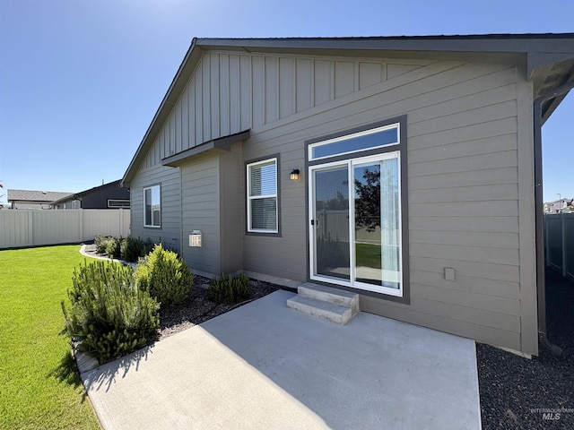 1786 E Cave Falls St, Kuna, ID 83634 - rear view of property featuring board and batten siding, a patio area, and entry steps
