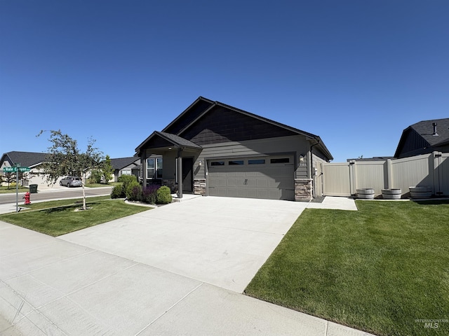 1786 E Cave Falls St, Kuna, ID 83634 - view of front of house featuring an attached garage, driveway, and stone siding