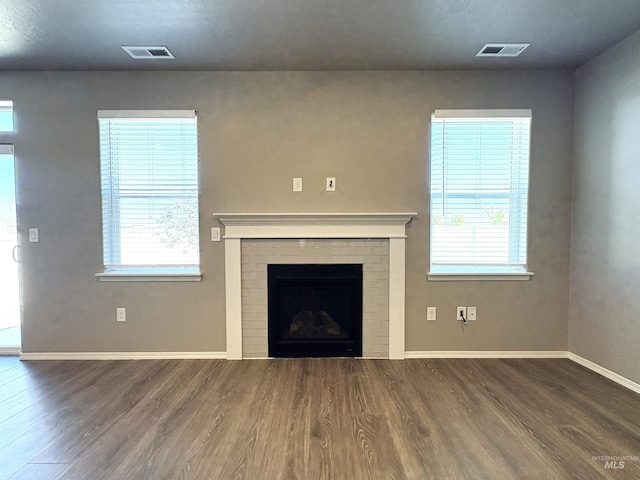 1786 E Cave Falls St, Kuna, ID 83634 - unfurnished living room featuring wood finished floors, baseboards, and healthy amount of natural light