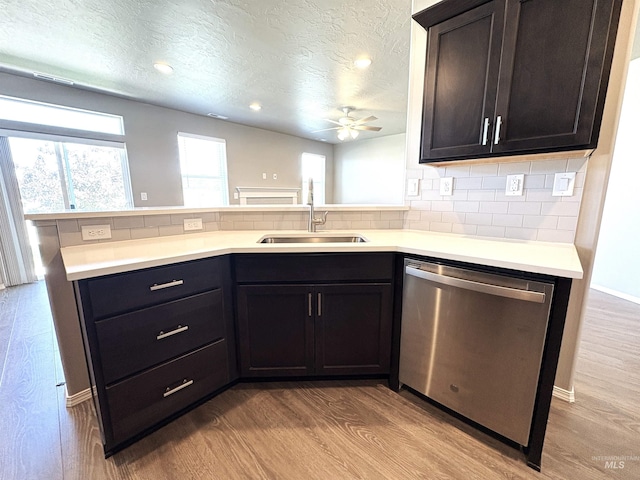 1786 E Cave Falls St, Kuna, ID 83634 - kitchen featuring dishwasher, a sink, a textured ceiling, ceiling fan, and wood finished floors
