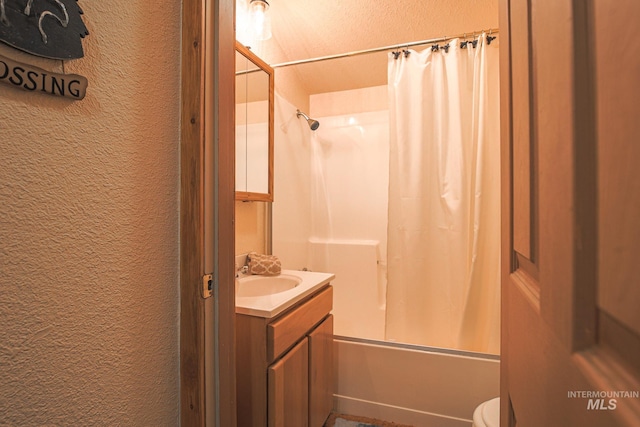 1102 Davis, Mccall, ID 83638 - full bathroom with a textured wall, shower / bath combination with curtain, vanity, and toilet
