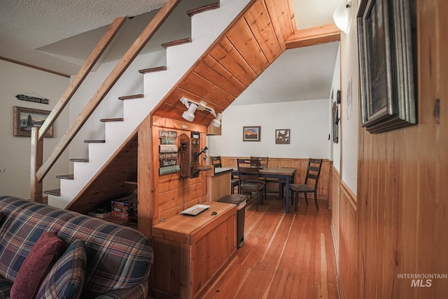 1102 Davis, Mccall, ID 83638 - living room featuring wainscoting, stairs, hardwood / wood-style flooring, and wooden walls