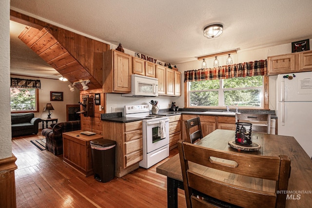 1102 Davis, Mccall, ID 83638 - kitchen with white appliances, dark countertops, wood-type flooring, a textured ceiling, and a sink