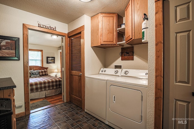 1102 Davis, Mccall, ID 83638 - laundry area featuring washing machine and clothes dryer, cabinet space, and a textured ceiling