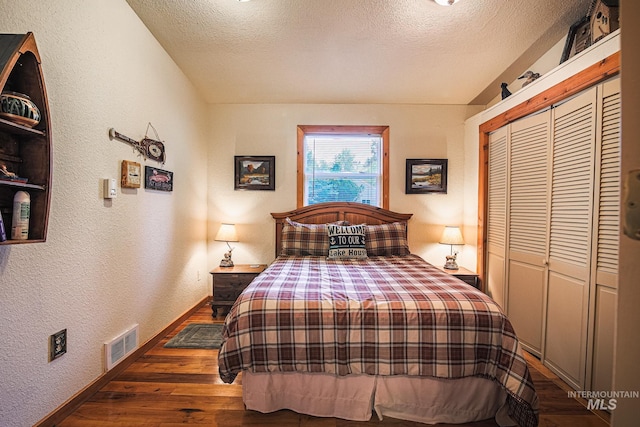 1102 Davis, Mccall, ID 83638 - bedroom featuring a textured wall, baseboards, hardwood / wood-style floors, a textured ceiling, and a closet