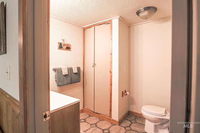 1102 Davis, Mccall, ID 83638 - bathroom with a textured ceiling, toilet, and a textured wall