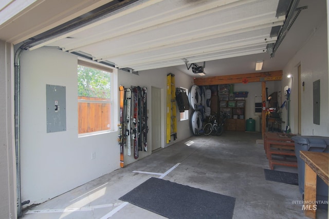 1102 Davis, Mccall, ID 83638 - garage featuring electric panel, a workshop area, and a garage door opener