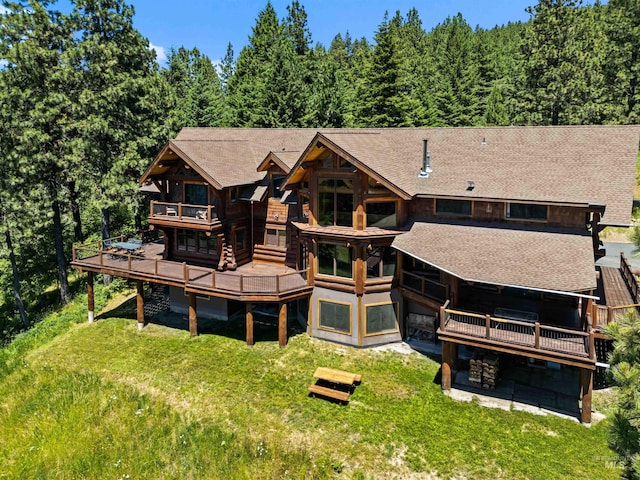 back of house with a lawn and a wooden deck