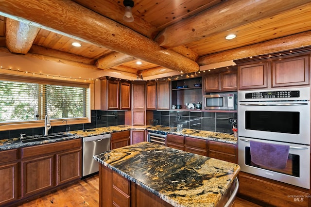 kitchen featuring sink, stainless steel appliances, beamed ceiling, a kitchen island, and wood ceiling