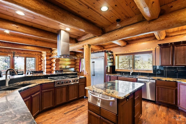 kitchen featuring island exhaust hood, appliances with stainless steel finishes, wood ceiling, sink, and log walls