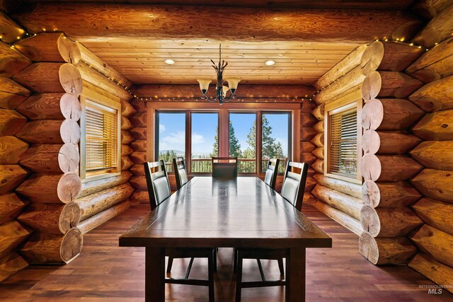 unfurnished dining area featuring log walls, an inviting chandelier, and wooden ceiling