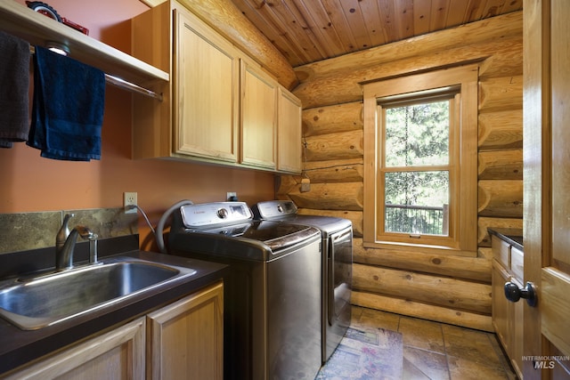 laundry room with cabinets, wooden ceiling, sink, log walls, and washing machine and clothes dryer