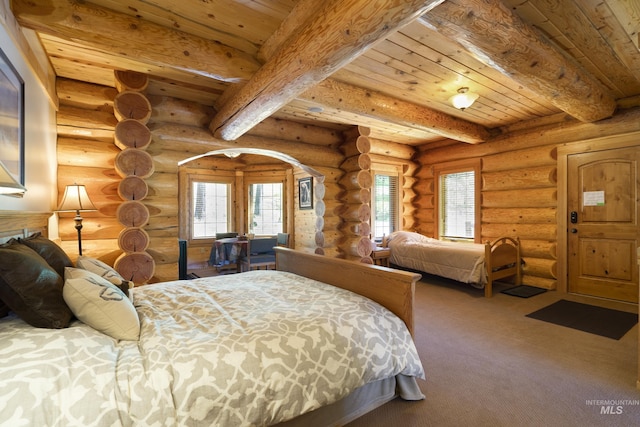 bedroom with beam ceiling, rustic walls, and wood ceiling