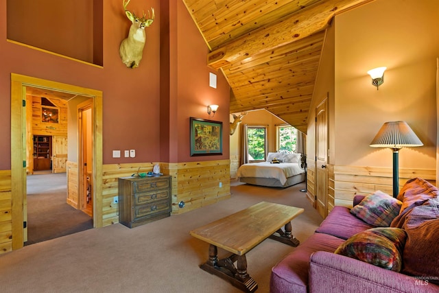 carpeted bedroom featuring wooden walls, high vaulted ceiling, and wooden ceiling