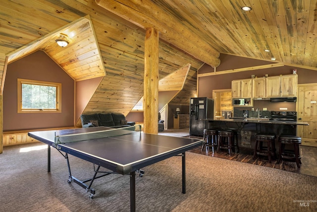 playroom featuring lofted ceiling with beams and dark colored carpet