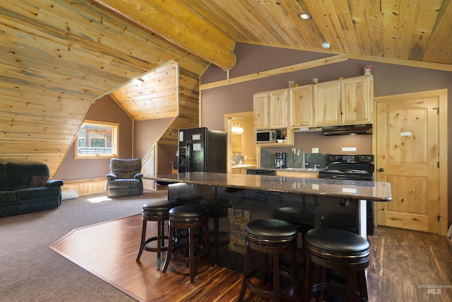 kitchen with a kitchen breakfast bar, vaulted ceiling with beams, light brown cabinets, and black appliances