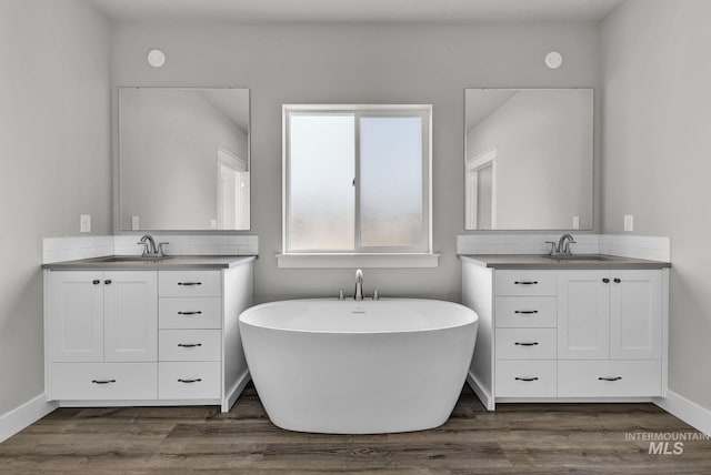 bathroom featuring vanity, a bathing tub, and hardwood / wood-style flooring