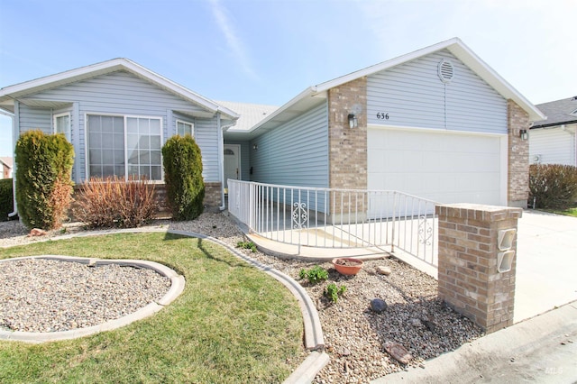 636 N Sterling St, Nampa, ID 83651 - single story home with a front yard, an attached garage, brick siding, and driveway