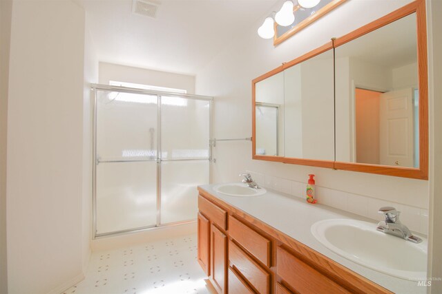 636 N Sterling St, Nampa, ID 83651 - bathroom featuring a shower stall, double vanity, visible vents, and a sink